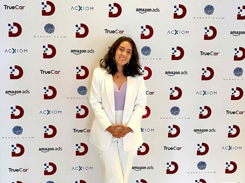 Tianna Mick standing in front of Digital Dealer backdrop