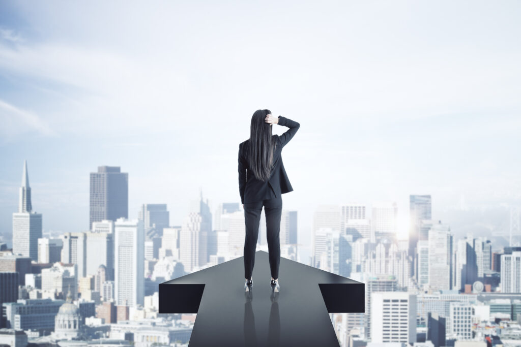 back view of young businesswoman standing on arrow 2026 03 26 05 25 30 utc